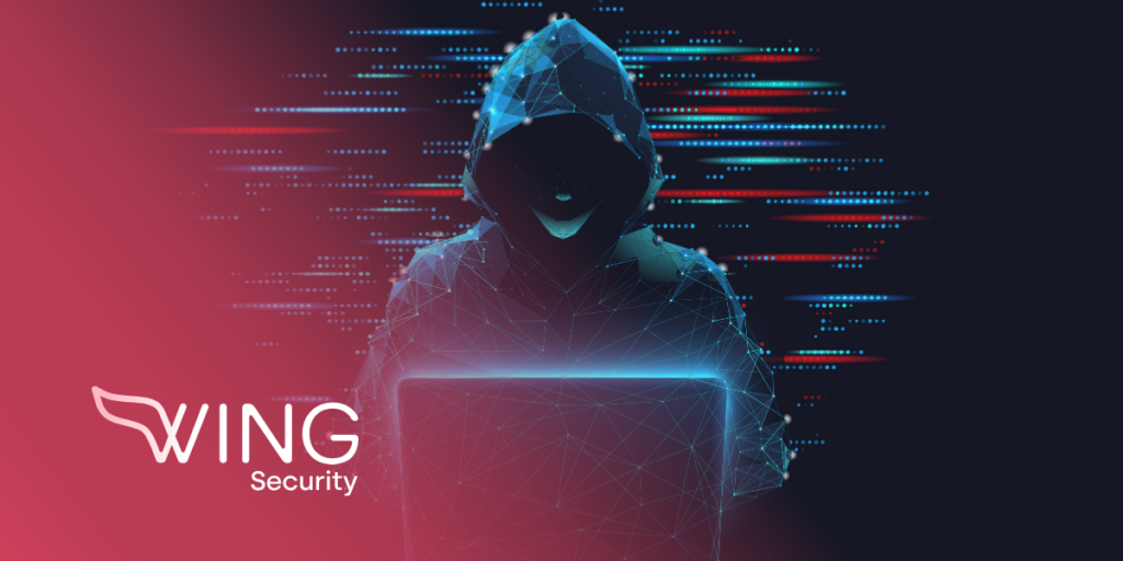 hacker with face covered breaking into a system